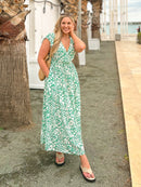 Model wearing a Susan wrap maxi dress lifestyle shot on a city street