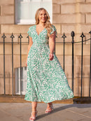 Model wearing a Susan wrap maxi dress lifestyle shot on a city street