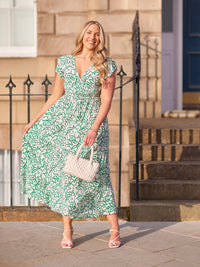 Model wearing a Susan wrap maxi dress lifestyle shot on a city street